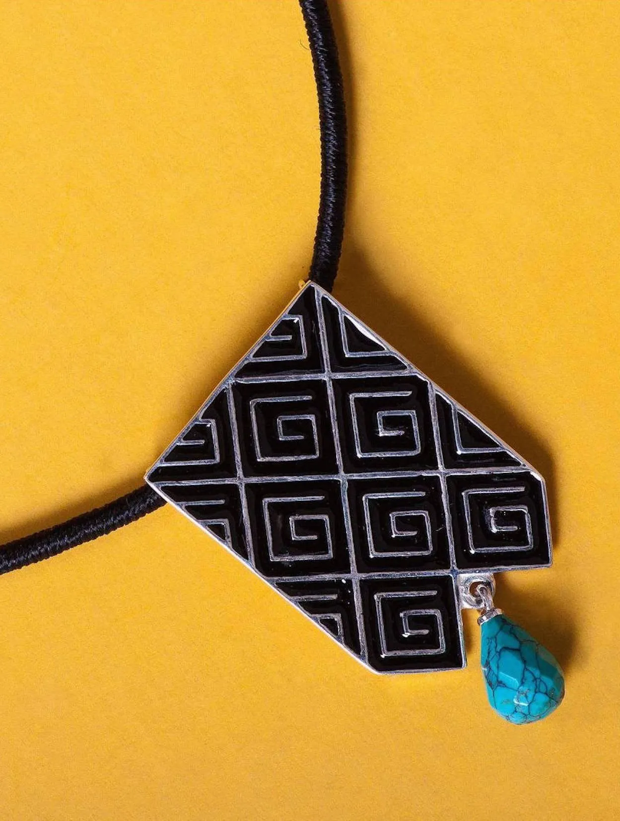 Stunning, long rectangular pendant with fine black enamel work and a turquoise drop