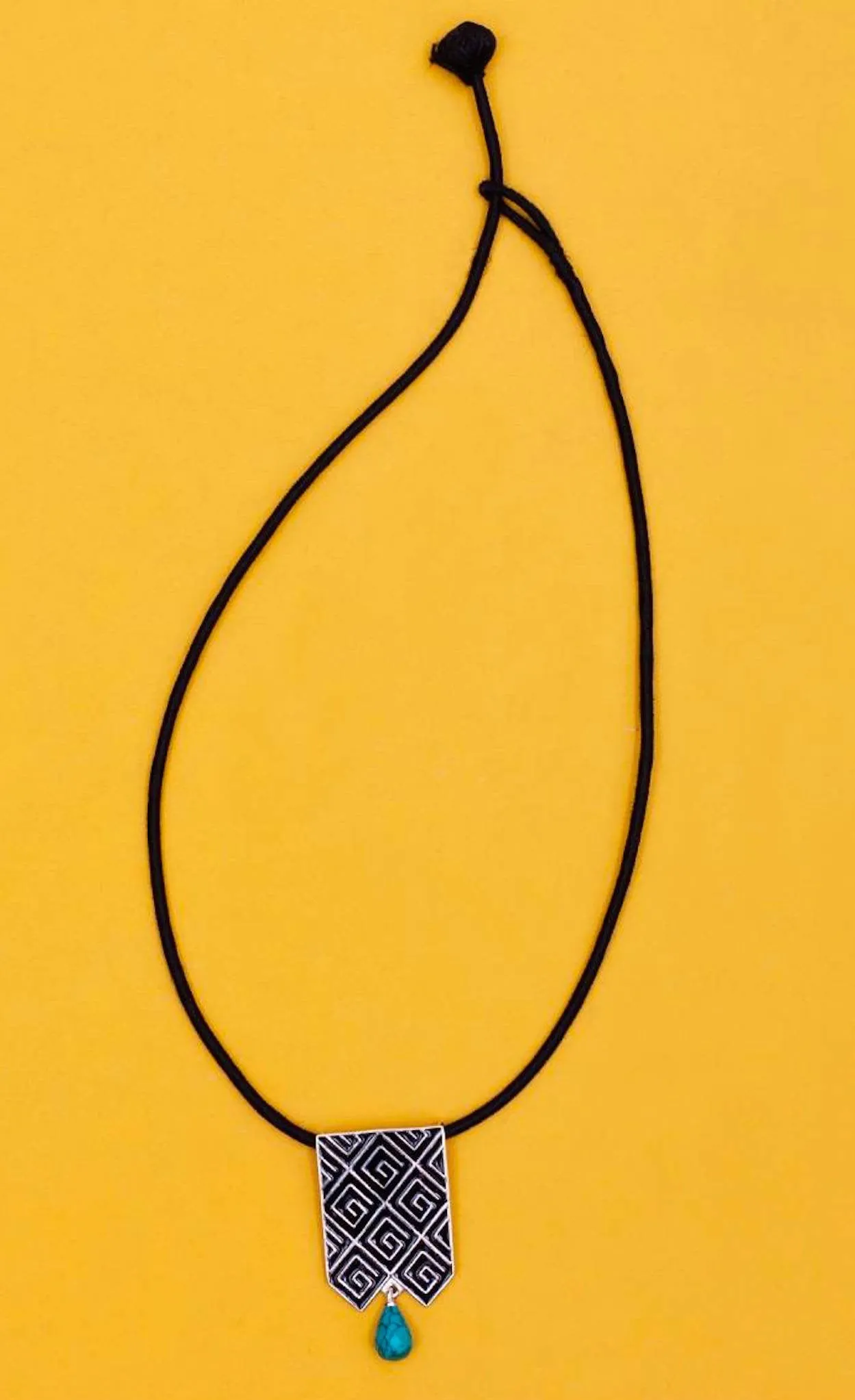 Stunning, long rectangular pendant with fine black enamel work and a turquoise drop